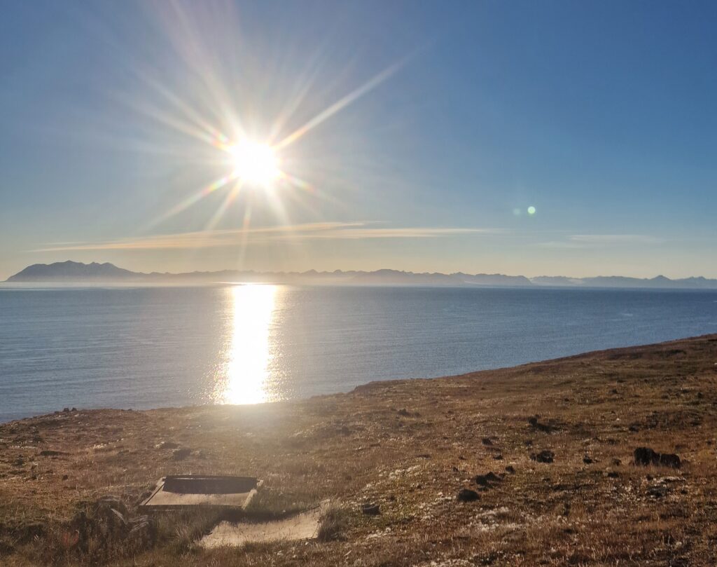 Sole su cielo blu in riva all'oceano